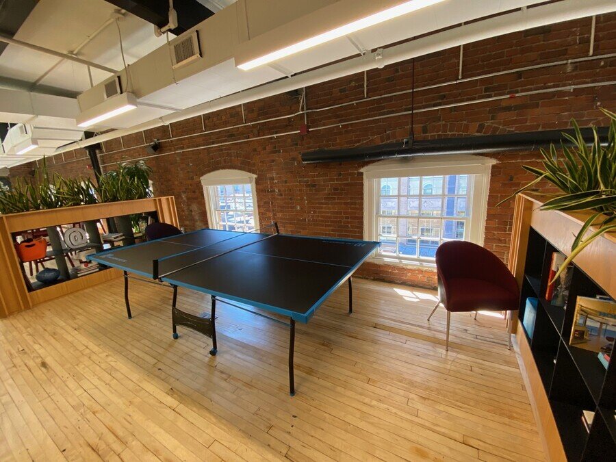 Common Space in office with brick walls and low windows