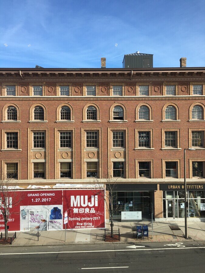 Newbury Street 5 floor office seen from the street building with MUJI signs on ground level